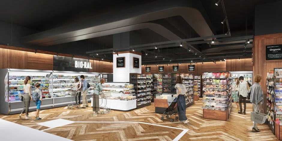 モダンなスーパーマーケットの店内風景。買い物客がBIO-RALやオーガニック食品の並ぶ棚から商品を選んでおり、明るく清潔感のある空間が特徴です。