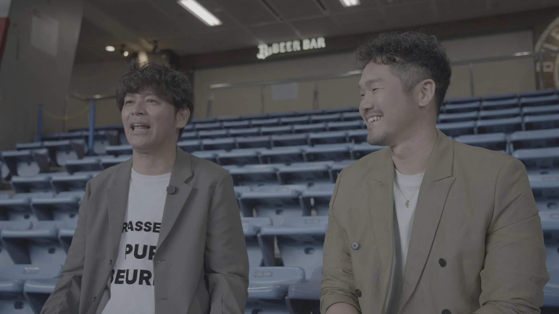 スタジアムで会話する男性二人