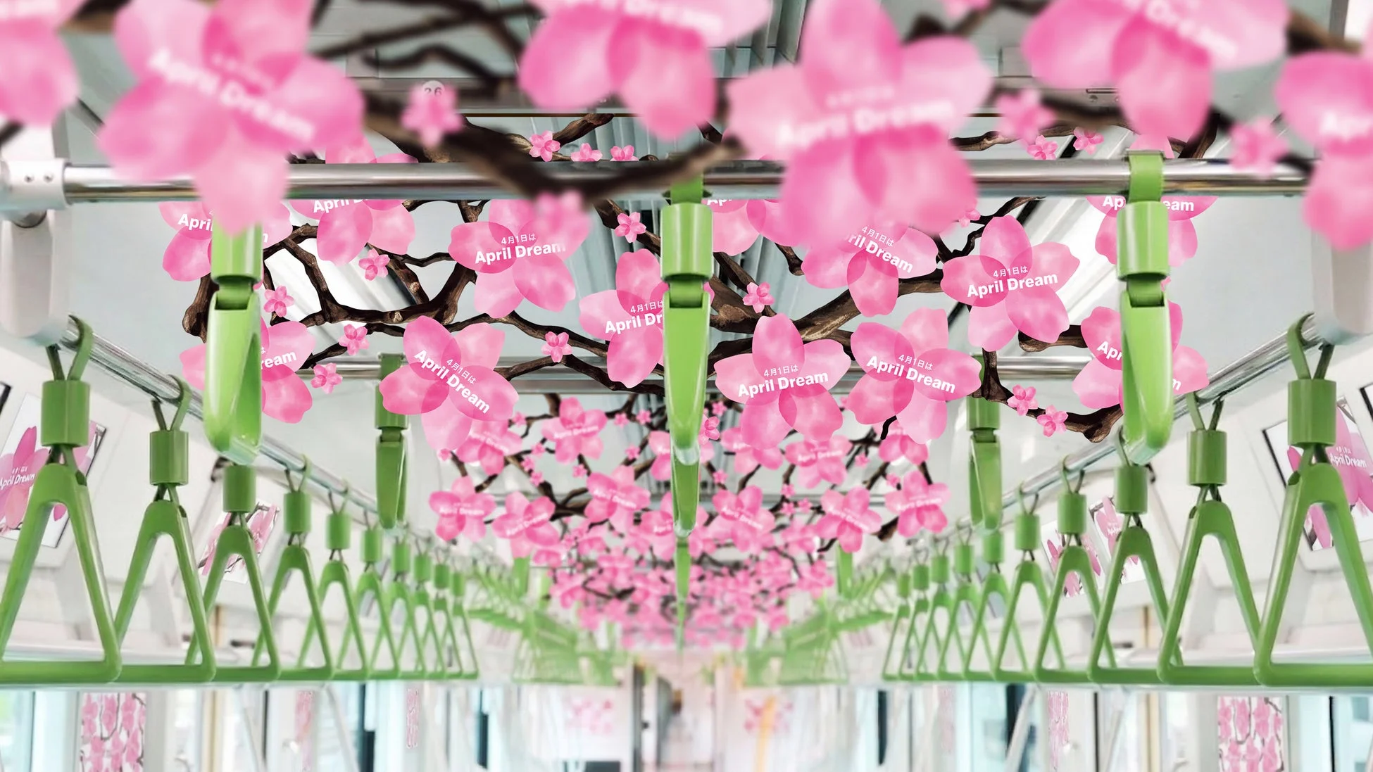 電車内に桜の装飾が施されており、ピンク色の桜の花びらと枝が天井を覆っています。