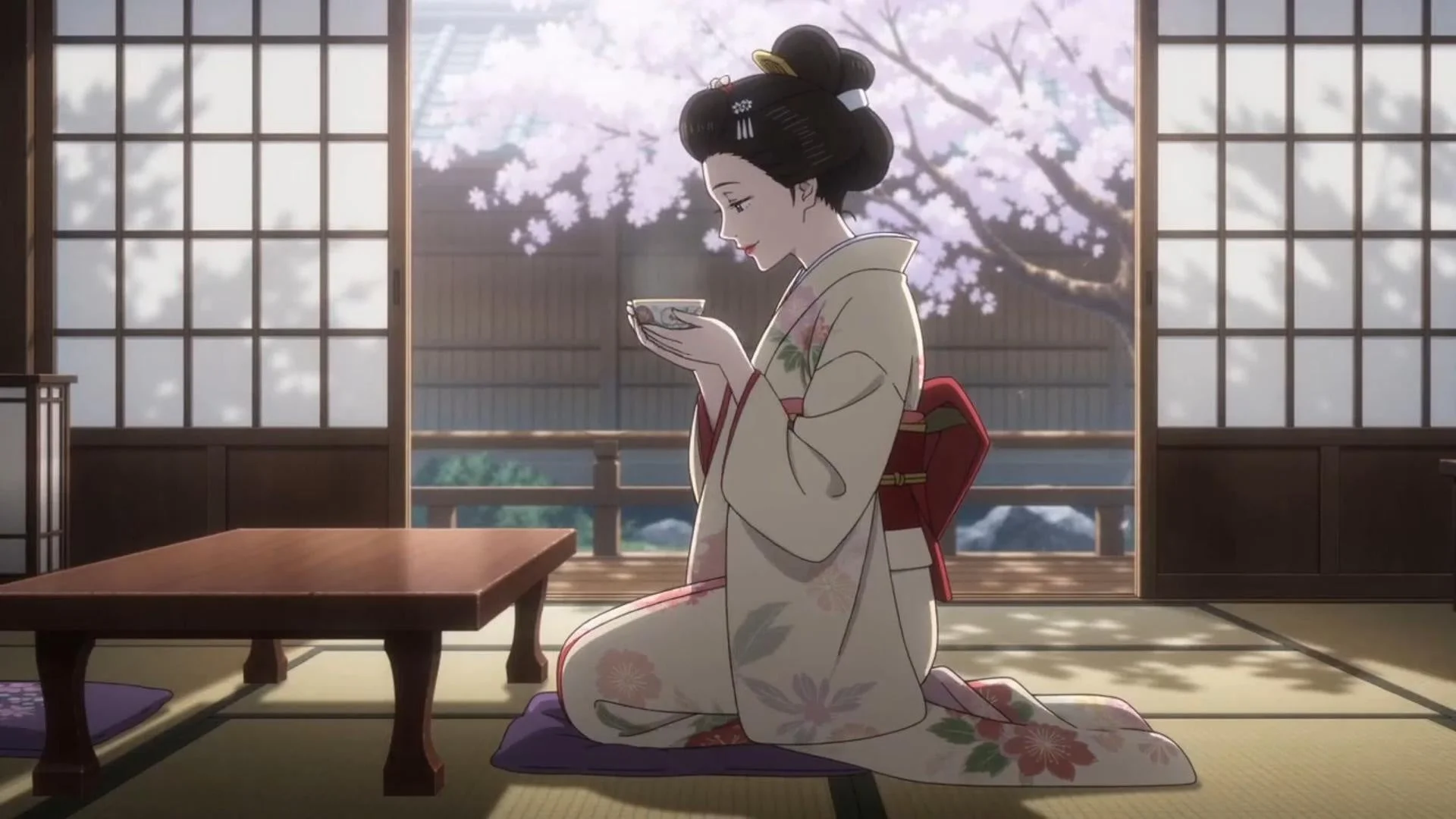 和室で着物を着た女性が桜を眺めながらお茶を飲んでいる