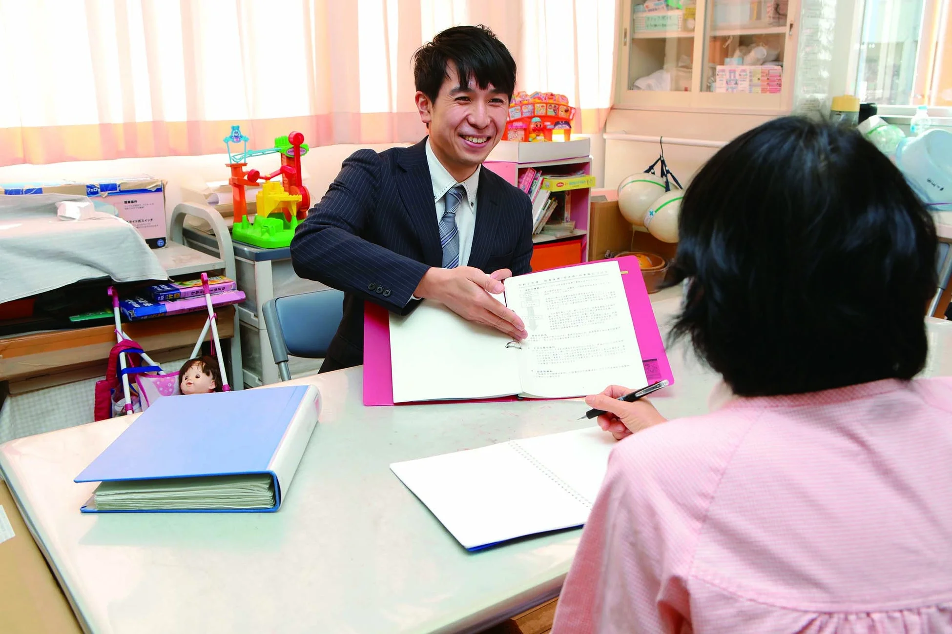 書類を説明する男性と話を聞く女性